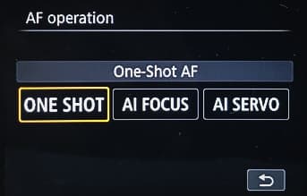A Canon camera menu for AF operation with One Shot selected, next to AI Focus and AI Servo