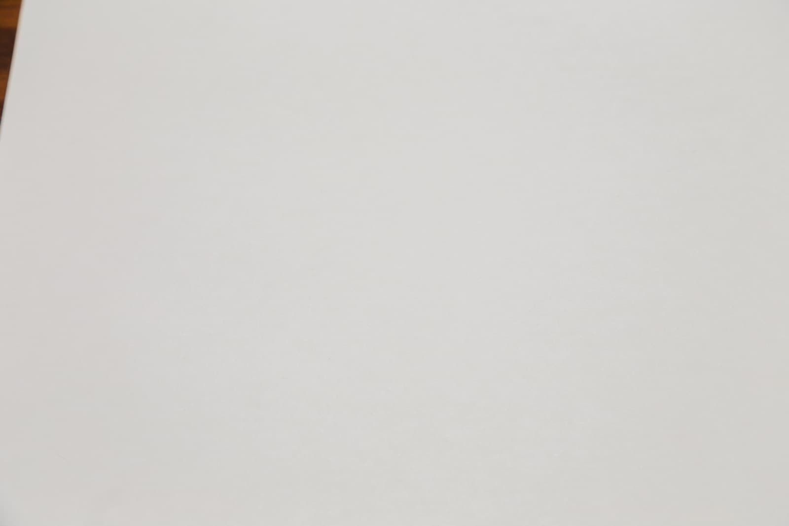 A close-up of the same sheet of paper, which looks light grey instead of white